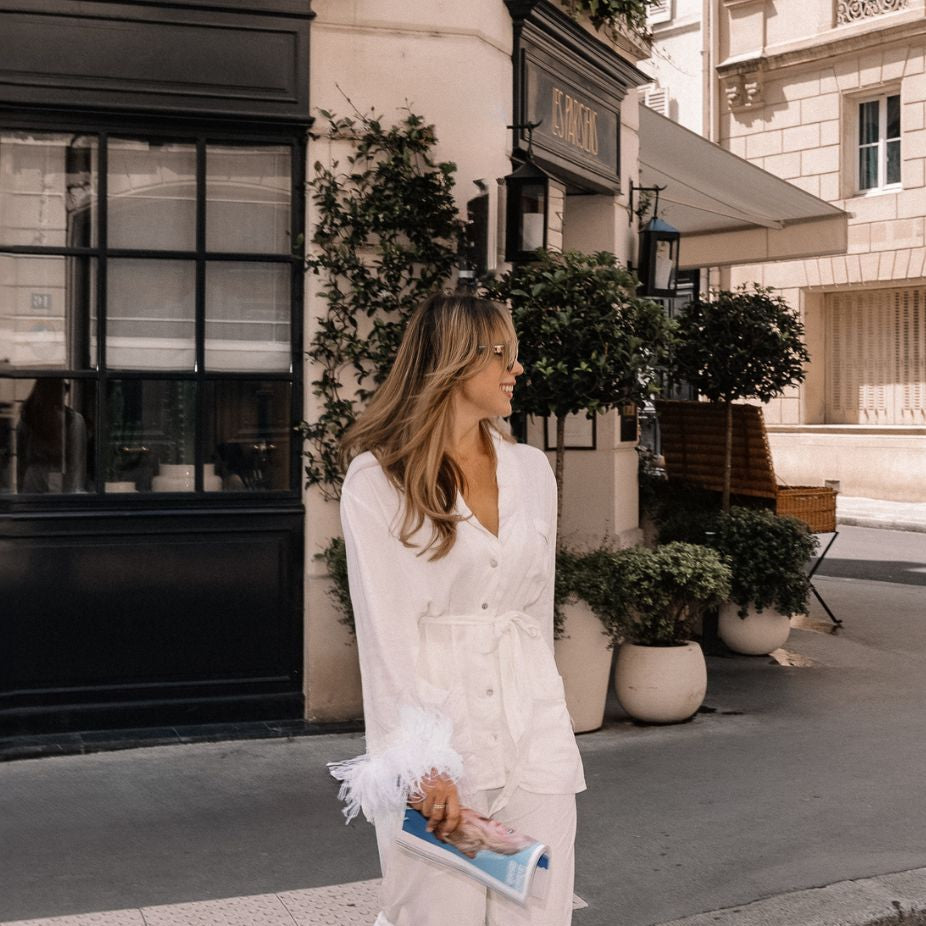 Ingrid Bonnor in Paris wearing white feather-trim pyjamas